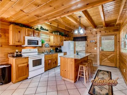 Full Kitchen with island countertop and stools